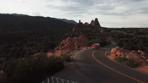 Drone shot of Volkswagen Bus drivng through the mountains Stock Footage