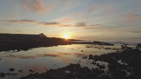 Drone shot of water surface reflecting beautiful sunset at Iceland Stock Footage 93390718