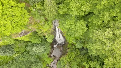 Drone shot of the waterfall Merisi. Drone shoots in a spiral. Stock Footage 198658166