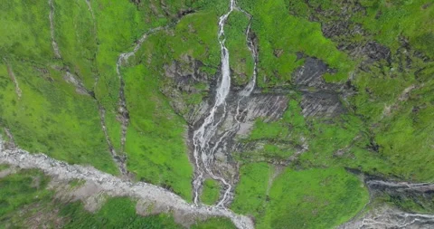 Drone shot of a waterfall in the mountains during Summer Stock Footage 283568994