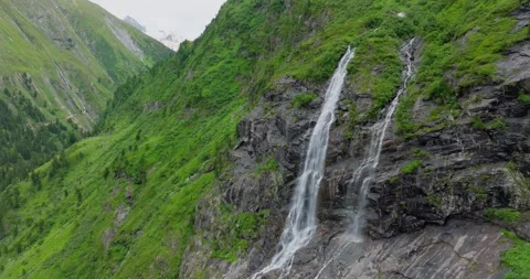 Drone shot of a waterfall in the mountains during Summer-5 Stock Footage 283572640