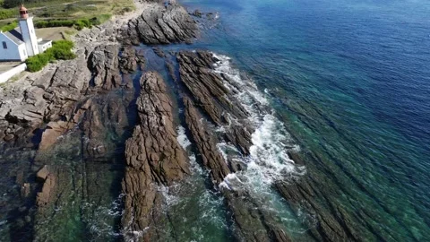 Drone shot of waves breaking on the rocks of the island of groix, island and a Stock Footage 137441812