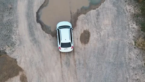 Drone Shot: White Car Splashes Through Puddle Stock Footage 285407494