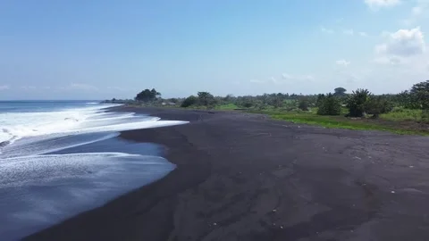 Drone Shot of White Ocean Foam Waves Crashing on Dark Volcanic Black Sand Shore Video stock 344991276