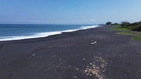 Drone Shot of White Ocean Foam Waves Crashing on Dark Volcanic Black Sand Shore 스톡 동영상 344991751
