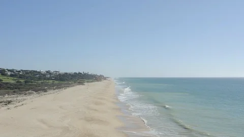 Drone Shot Of Wide Sandy Almost Empty Beach During Spring Stock Footage 128845929