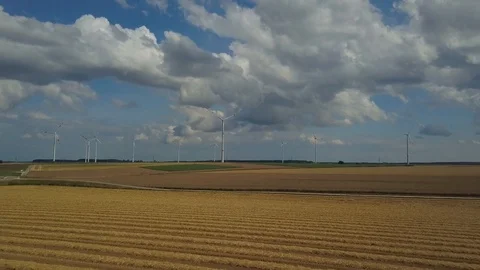 Drone shot of wind turbines in corn fields against cloudy sky Stock Footage 120044698