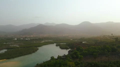 Drone Shot of Winding River Delta and Misty Mountains at Golden Hour Stock Footage 341627188