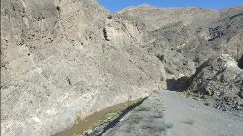 Drone shot to windy river in steep rocky canyon 스톡 동영상 99313771