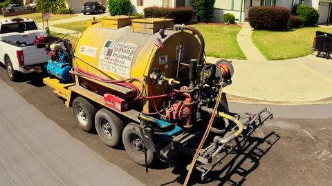 Drone shot of workers applying a cool pavement reflecting spray Stock Footage 341247083