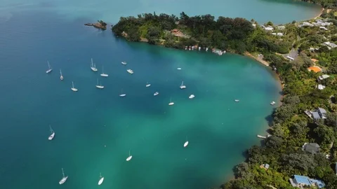Drone shot of yachts floating in a clear blue bay in New Zealand Stock Footage 87723284