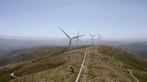 Drone shots of wind generators on top of a mountain. Side tracking. Portugal Stock Footage 128632145
