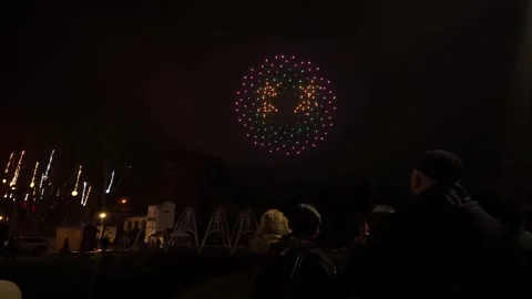 Drone Show Making a Circular Pattern Over Crowd at Night Stock Footage 322915541