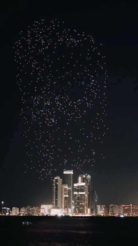 Drone show in night sky over Bluewaters and JBR Beach promoting Dubai Shopping Stock Footage 304746290