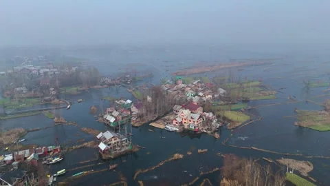 Drone showcasing a peaceful, mist-covered morning on Srinagar’s frozen Dal Lake. Stock Footage 311020551