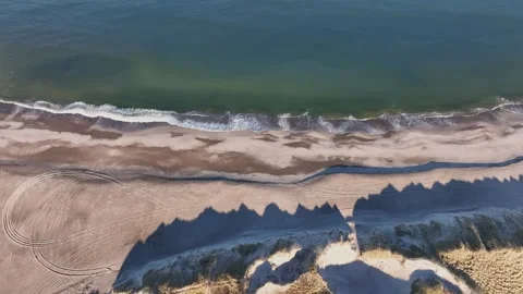 Drone shows empty North Sea beach with sand dunes, no people, and a stable Stock Footage 306681620