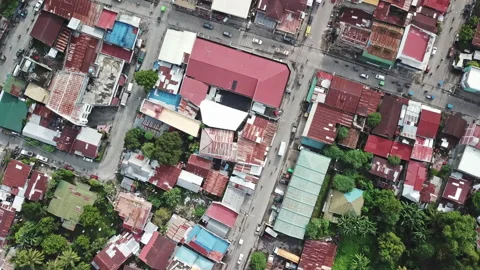 The drone shows the irregular architecture of a small Asian city. Video stock 99675138