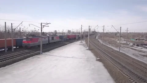 Drone shows the movement of a freight train through winter landscapes Stock Footage 162346022