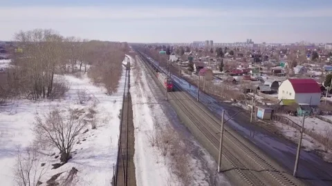 Drone shows the movement of a freight train through winter landscapes Stock Footage 162346189