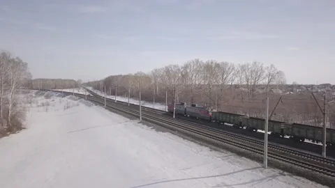 Drone shows the movement of a freight train through winter landscapes Stock Footage 162346465