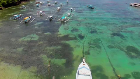 Drone shows Padang Bai Beach in East Bali, a scenic coastal destination with a h Stock Footage 309257531