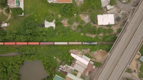 Drone shows top-down freight train passing through Vietnam Vídeos de archivo 255688275