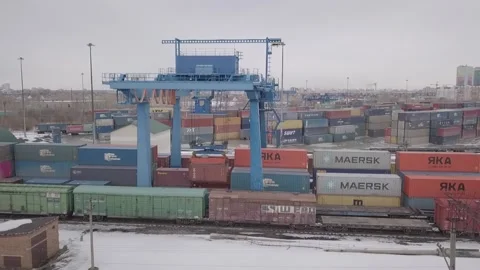 Drone shows the work of a large container crane on the railway Stock Footage 157692093