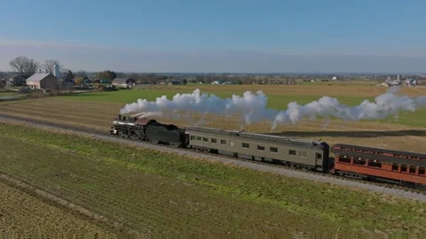 Drone Side and Slightly Behind View of a Steam Passenger Train, Blowing Smo.. Stock Footage 238653057