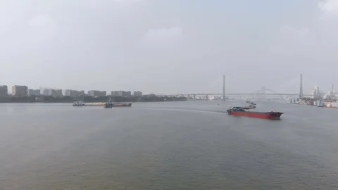 Drone side flight, a large number of cargo ships sailing along the river Stock Footage 118029643