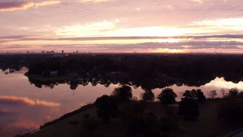 Drone side move down a river with Norfolk and the sun centered Stock Footage 119918140