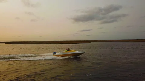 Drone side track of yellow speed boat on bay Stock Footage 148511270