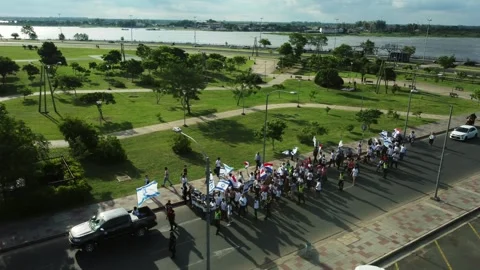Drone side tracking shot of public march at Costanera in Asuncion Video stock 335172413