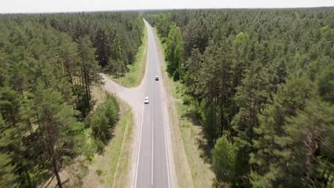 Drone Side View Camera Tracking Car Driving On Empty Road Stockbeeldmateriaal 243512136