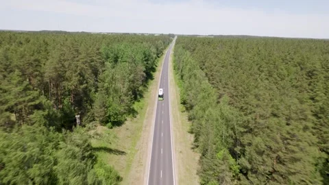 Drone Side View Camera Tracking Car Driving On Empty Road Video stock 243512145