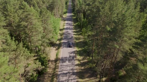 Drone Side View Camera Tracking Car Driving On Empty Road Stockbeeldmateriaal 243597615