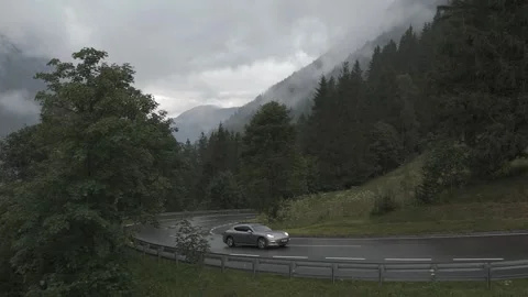 Drone Side View of Car Driving on an Alpine Road Stock Footage 280307244