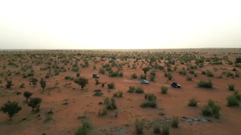 Drone Side View of Three 4x4 Vehicles Driving Through African Savanna Stock Footage 341517138