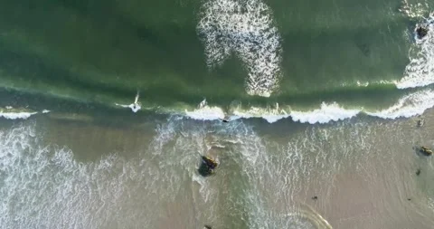 Drone side view video shot in zenithal view along the shore of a turquoise .. Stock Footage 294827454
