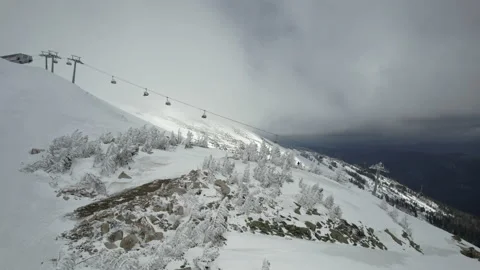 Drone ski lift moving through clouds in winter resort Stock Footage 180050005