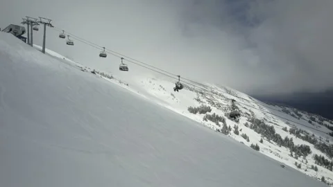 Drone ski lift moving through clouds in winter resort Stock Footage 180051385