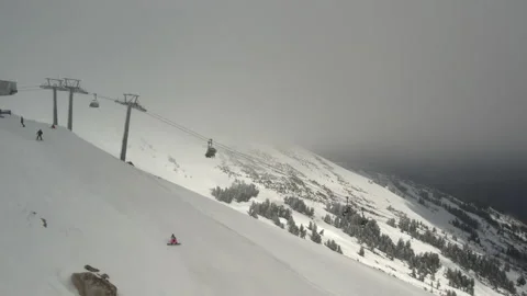 Drone ski lift moving through clouds in winter resort Stock Footage 180053300