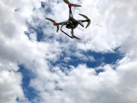 Drone in the sky with clouds. Stock Photos