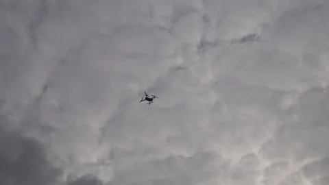 A drone up in the sky on a cloudy day. Stock Footage 116794784