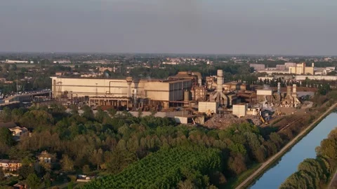 Drone slide with pullback over Acciaieria Arvedi beside Idrovia canal in Cremona Video stock 334712409