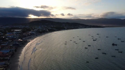 Drone slide right over the bay of a small fishing town Stock Footage 331358404