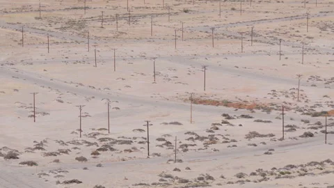 Drone Slide Shot of Power Lines Along Abandoned Streets in Salton City Stockbeeldmateriaal 332638888