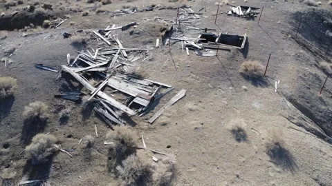 Drone slider move over ruins and mine shaft in the nevada desert Stock Footage 243698949