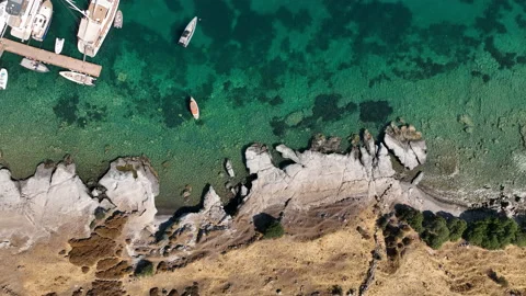 Drone sliding to left with view of clear green sea Stock Footage 235197830