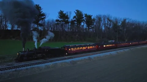 Drone Slightly Ahead and Parallel Night View of a Steam Passenger Train Sto.. 스톡 동영상 246426980