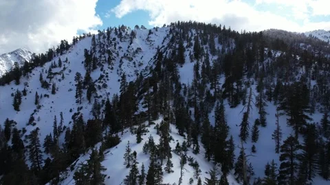 Drone sloping up snow covered mountain Stock Footage 172264870